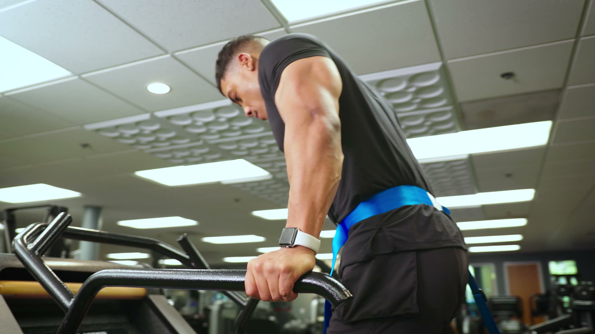 An athlete training on commercial gym equipment, from Total Body Experts' footage.